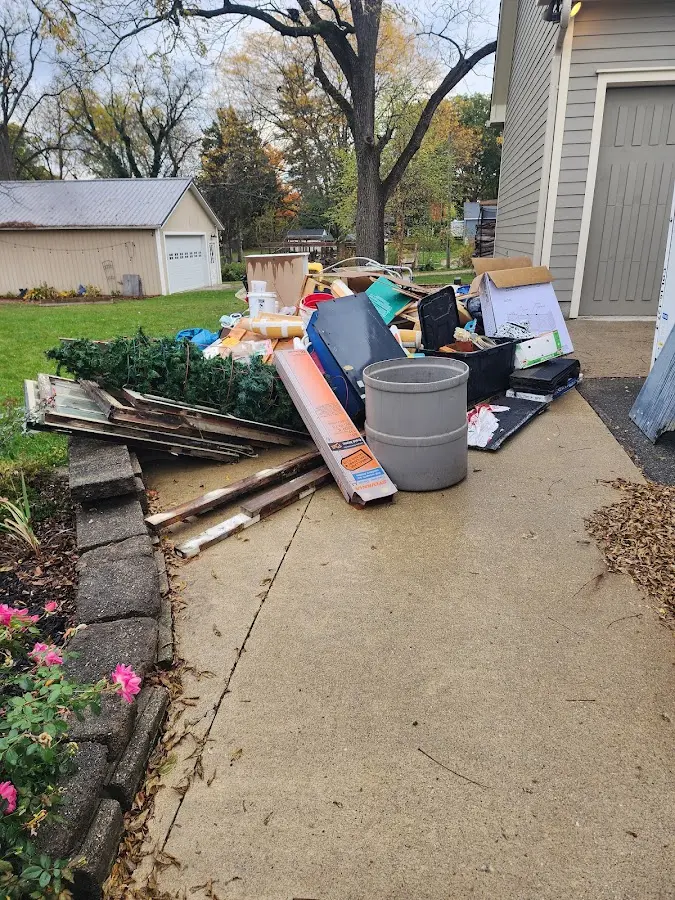 Dumpster being loaded with debris for Estate Cleanout Dumpster Rental in Lexington